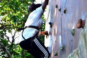 Guest ascends the climbing wall at Lakeside Adventure Park, Uganda