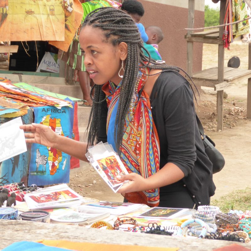 Woman at a local craft market for craft shopping in Uganda