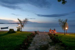Guests enjoy some outside dining on the shore of Lake Victoria at Brovad Sands, Bugala Island, Uganda