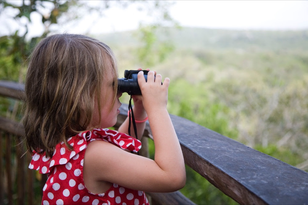 Girl admires the view of Uganda from Mihingo Lodge