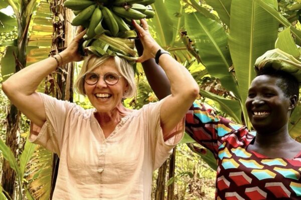 Venture Uganda guest trying to carry bananas on here head