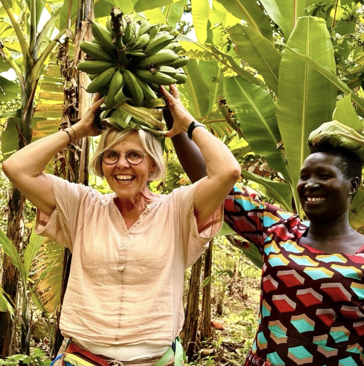 Venture Uganda guest trying to carry bananas on here head